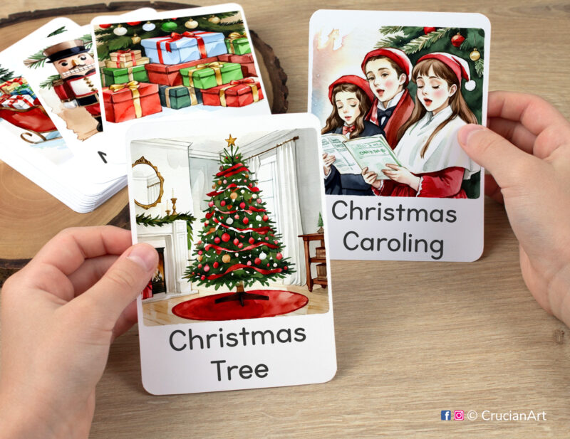 Preschooler hands holding flashcards with watercolor images of Christmas Tree and Christmas Caroling. Set of winter holiday season visual cards. Xmas time week printables.