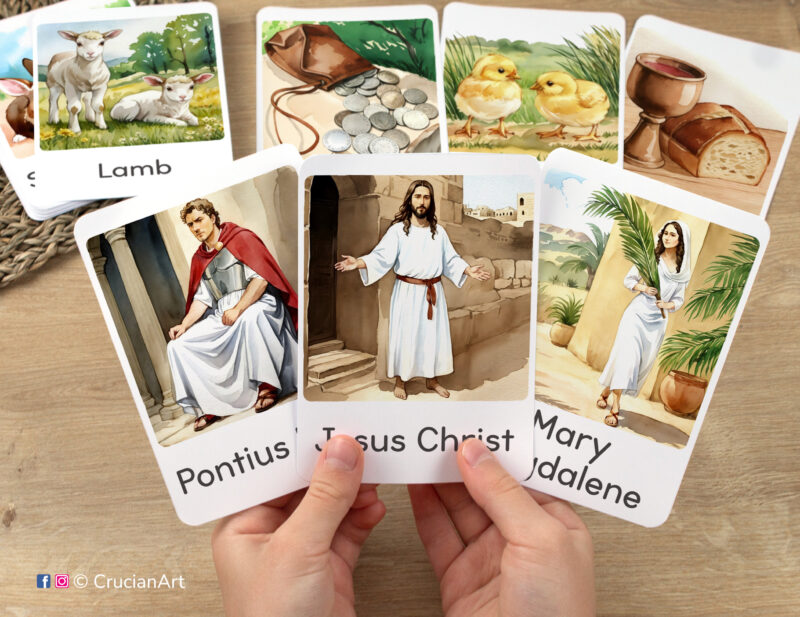 Flashcards featuring illustrations of Jesus Christ, Mary Magdalene and Pontius Pilate in toddler's hands