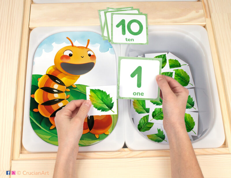 Spring and Summer Season theme Flisat insert resource in a Montessori preschool: early math counting activity placed on an IKEA Children's Sensory Table. Hungry caterpillar and leaves illustration for kids sensory table insert.