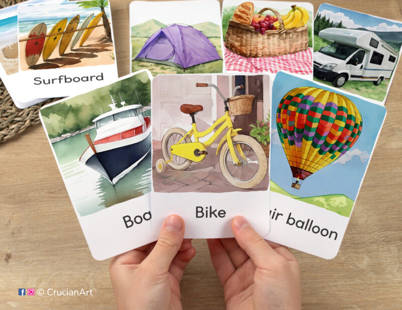 Flashcards featuring watercolor illustrations of watermelon, boat, and hot air balloon in toddler's hands. Vacation Season visual cards for seasonal vocabulary boosts.