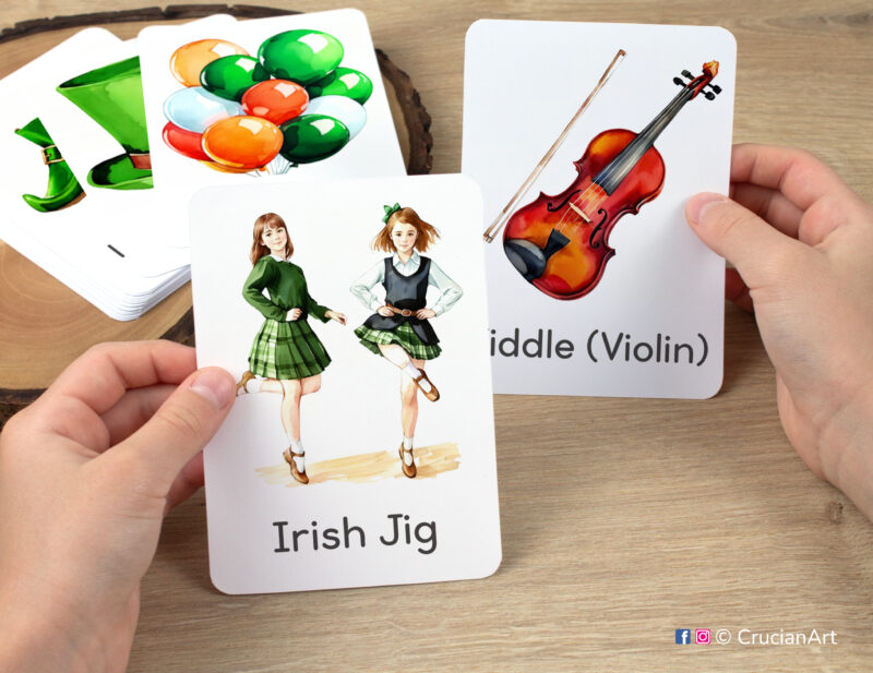 Young learner holding flash cards with images of Fiddle (Violin) and Irish Jig