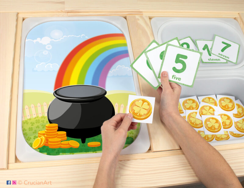 Toddler sensory bins play: Rainbow and Leprechaun Pot of Gold worksheet for an educational activity. DIY template inserted into IKEA Flisat table, with gold coins counters placed in the Trofast box.