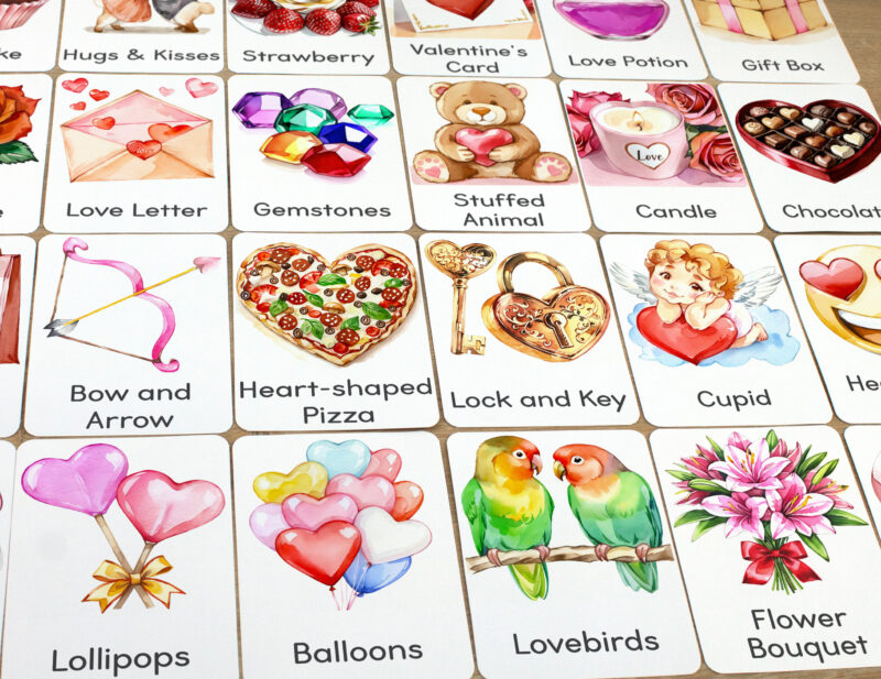 Set of Saint Valentine Day flashcards laid out on the table for learning activity: Lovebirds, Heart-shaped Balloons, Bow and Arrow, Lock and Key, Heart-shaped Lollipops, Cupid, Flower Bouquet, Heart-shaped Pizza.
