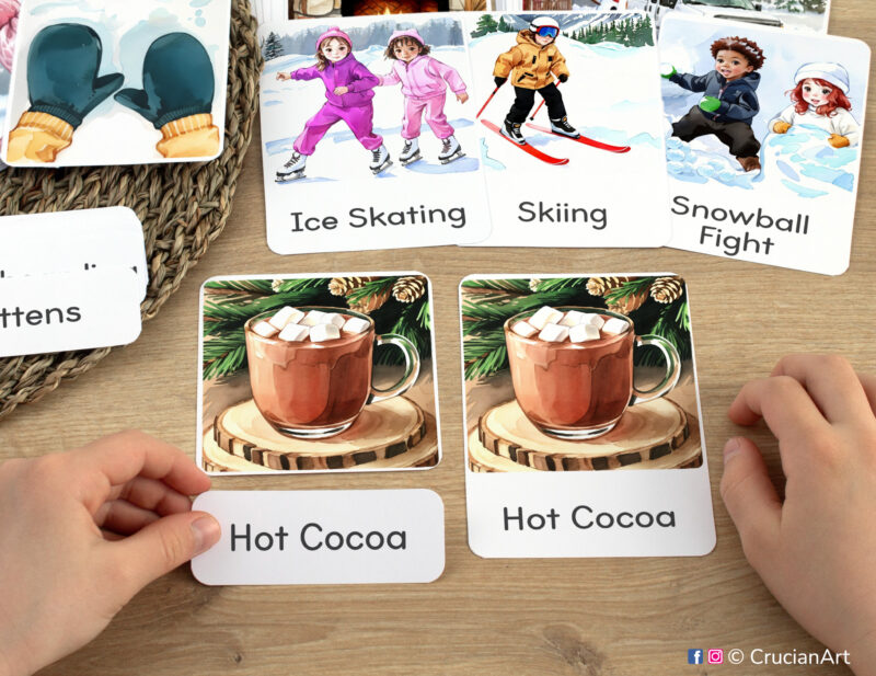 Winter Season three part cards in use: preschooler matching a word label to an image card of Cup of Hot Cocoa. Printables for Winter Wonderland curriculum classroom resources.