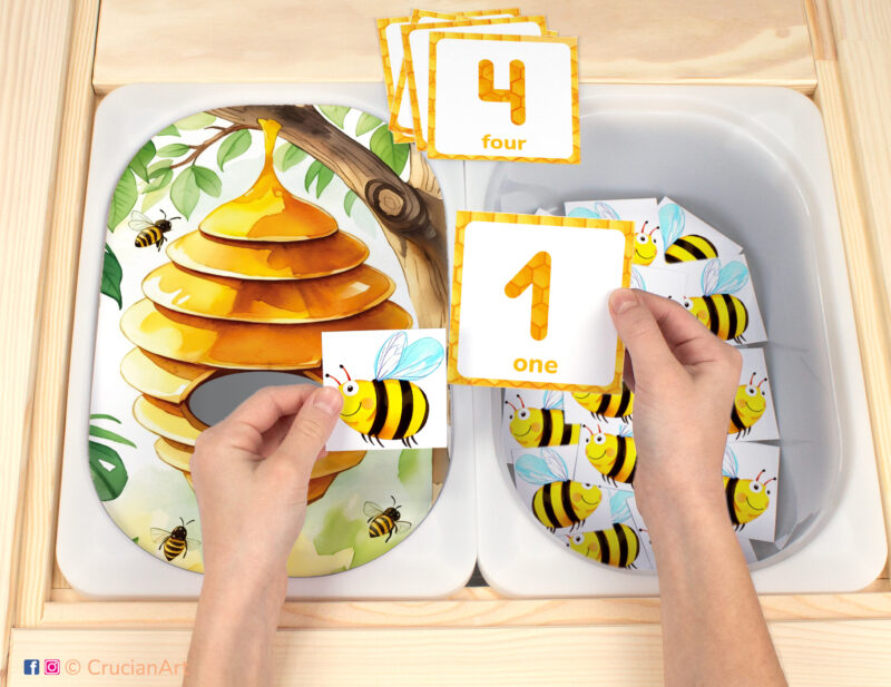 Insect theme Flisat insert resource in a Montessori preschool: early math counting activity placed on an IKEA Children's Sensory Table. Beehive and wild honeybees illustration for kids sensory table insert.