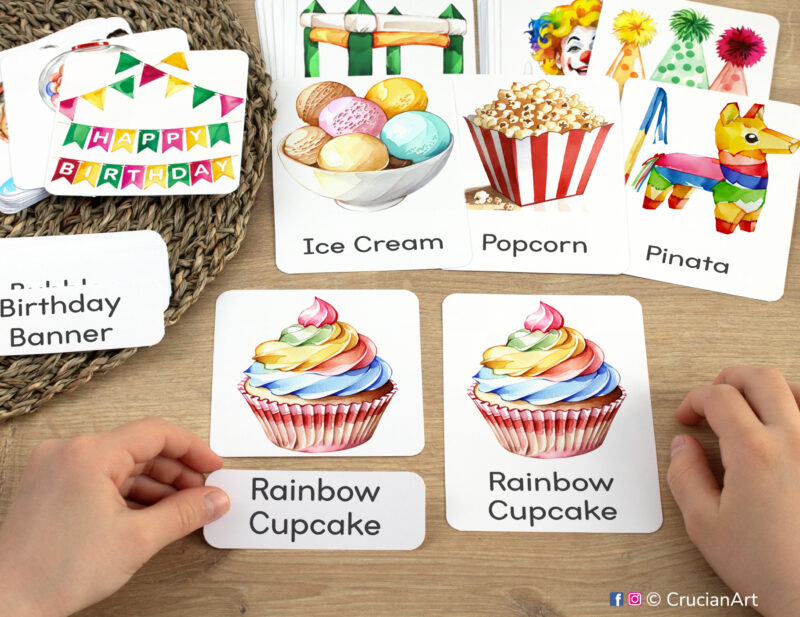 Birthday party three part cards in use: preschooler matching a word label to an image card of a rainbow cupcake. Printables for homeschool classroom. Printable activity for three and four year old kids.