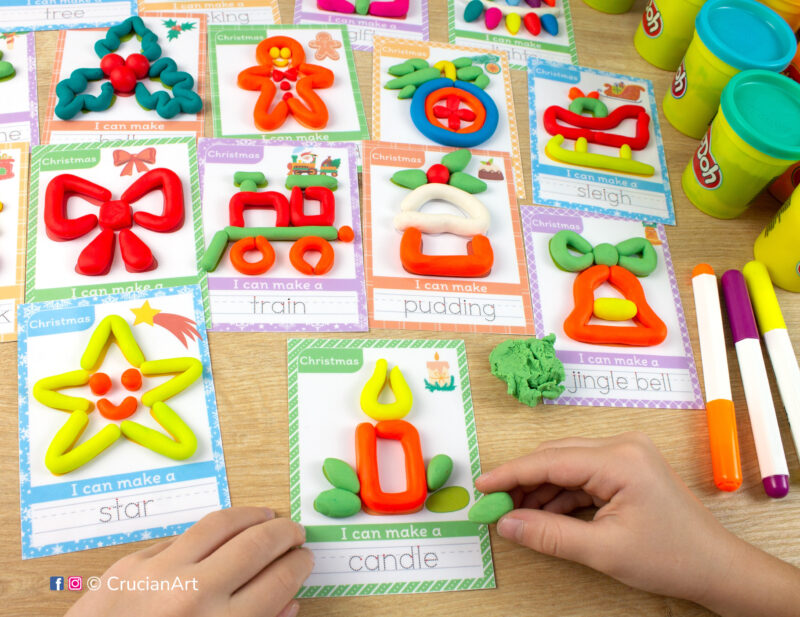 A preschooler is playing with play-doh, molding a Christmas candle. Christmas holiday season Montessori-inspired playdough mats for toddlers fine motor skill development.
