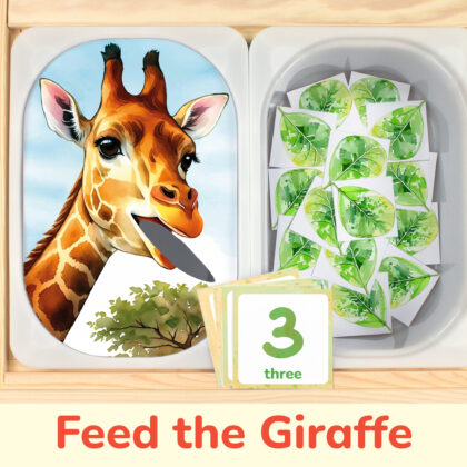 Feed the giraffe leaves counting activity placed on trofast boxes in ikea flisat children's sensory table. African safari and savannah theme toddler activity.