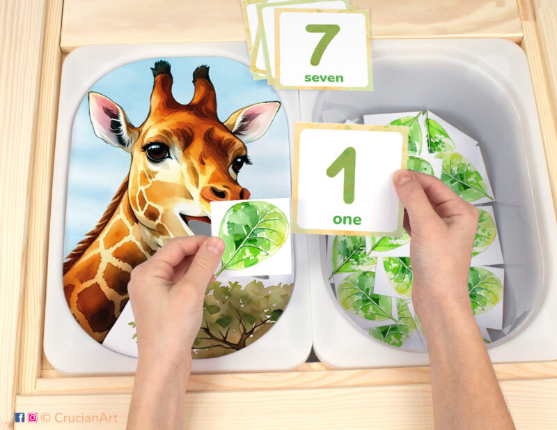 Feed the giraffe leaves flisat insert resource in a Montessori preschool: early math counting activity placed on an ikea children's sensory table. African safari and savannah theme play for kids sensory table insert.