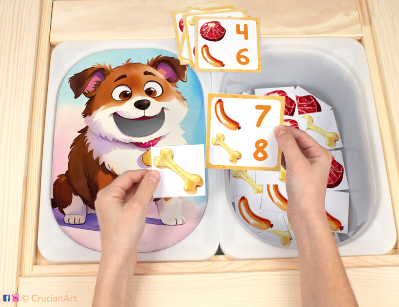 Feed the Hungry Puppy Flisat insert resource in a Montessori preschool. Pets-theme early math counting activity placed on an IKEA children's sensory table.