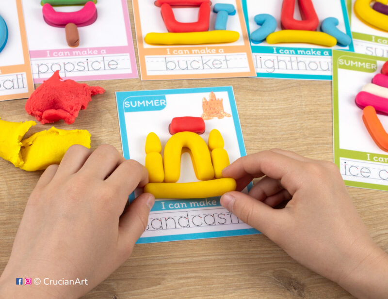 A preschooler is playing with play-doh, molding a sandcastle. Summer season Montessori-inspired playdough mats for toddlers fine motor skill development.