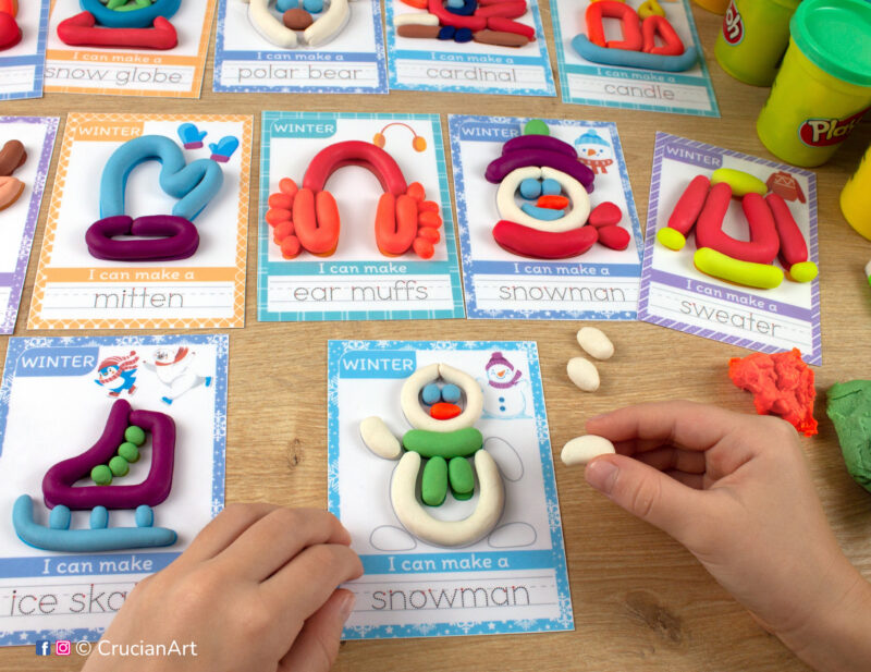 A preschooler is playing with play-doh, molding a snowman. Winter season Montessori-inspired playdough mats for toddlers fine motor skill development.