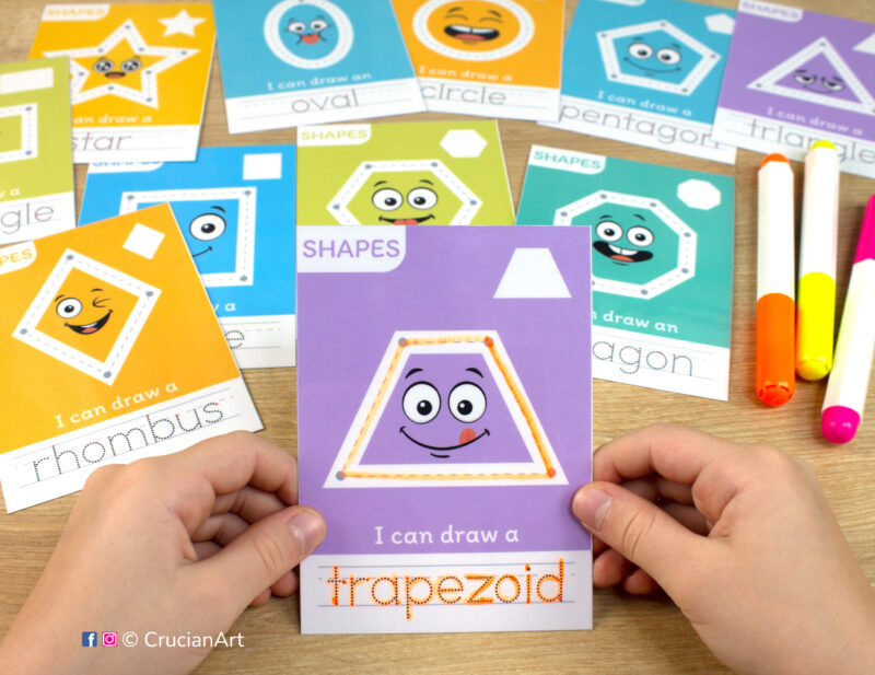 Printable cards to learn about geometric shapes. A toddler holds a flashcard with a trapezoid. Educational printables for preschool curriculums and kindergarten classrooms.