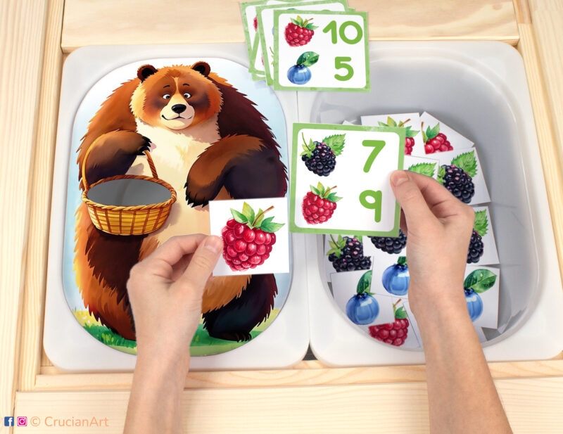 Feed the hungry brown bear berries Flisat insert resource in a Montessori preschool. Woodland animals-theme early math counting activity placed on an IKEA children's sensory table.