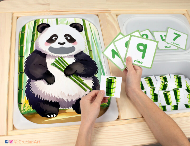 Feed the panda bamboo sensory bins play for toddlers: Animals of Asia theme worksheet for an educational activity. DIY template inserted into ikea flisat table, with counters placed in the trofast bin.