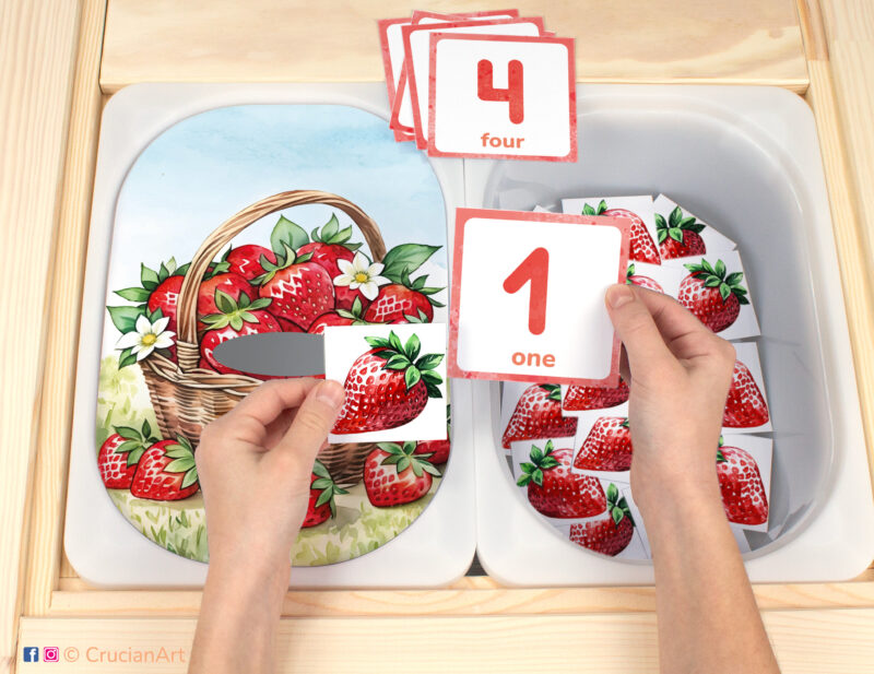Strawberry in the garden flisat insert resource in a Montessori preschool: early math counting activity placed on an ikea children's sensory table. Summer season play for kids sensory table insert.