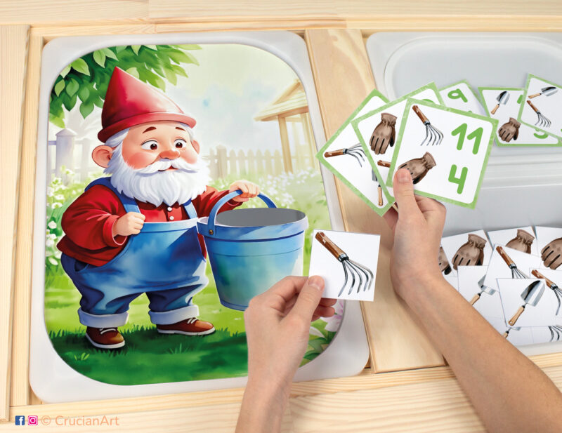 Garden gnome worksheet for an educational counting activity inserted into IKEA Flisat table and counters with gardening tools placed in the Trofast bin.