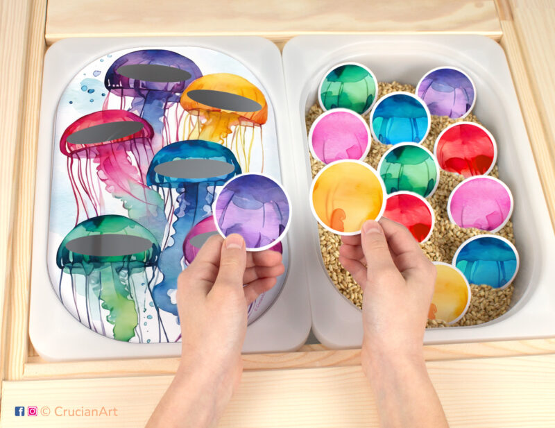 Printable summertime template inserted into IKEA flisat table bins. Jellyfish color sorting activity for toddlers.