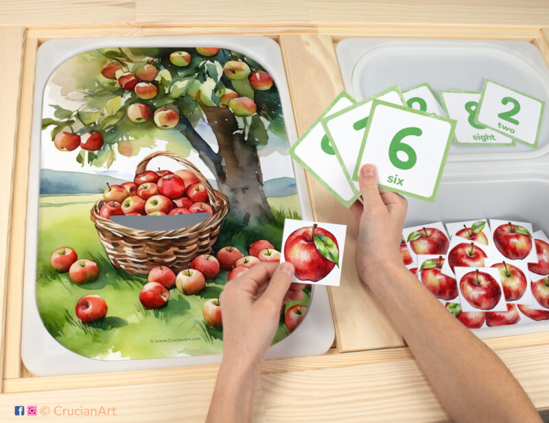 Apple counting game for toddlers: summer fruit and autumn harvest theme worksheet for an educational activity. DIY template inserted into ikea flisat table, with counters placed in the trofast bin.