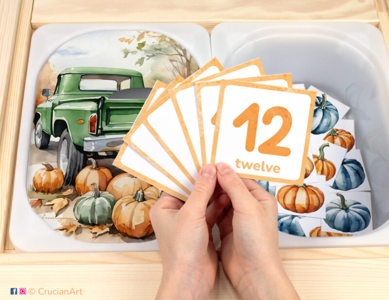 Pick up pumpkins in a truck pretend play setup. Sensory table insert and kids hands holding task cards displaying numerals from 1 to 12. Printable activity for the autumn harvest unit.