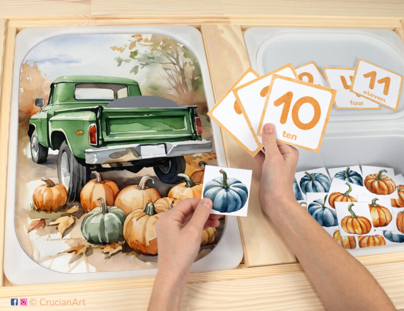 Pumpkin counting game for toddlers: autumn harvest theme worksheet for an educational activity. DIY template inserted into ikea flisat table, with counters placed in the trofast bin.