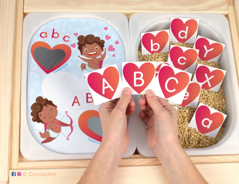 Big and small alphabet letters matching activity for toddlers and preschoolers. Printable insert template for Ikea flisat table and trofast bins. Saint Valentine Day DIY learning resource for homeschool classrooms. Brown skin Cupids holding bow and arrow and hearts.